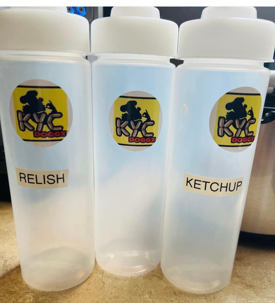 KYC Doggz branded condiment bottles — Relish and Ketchup