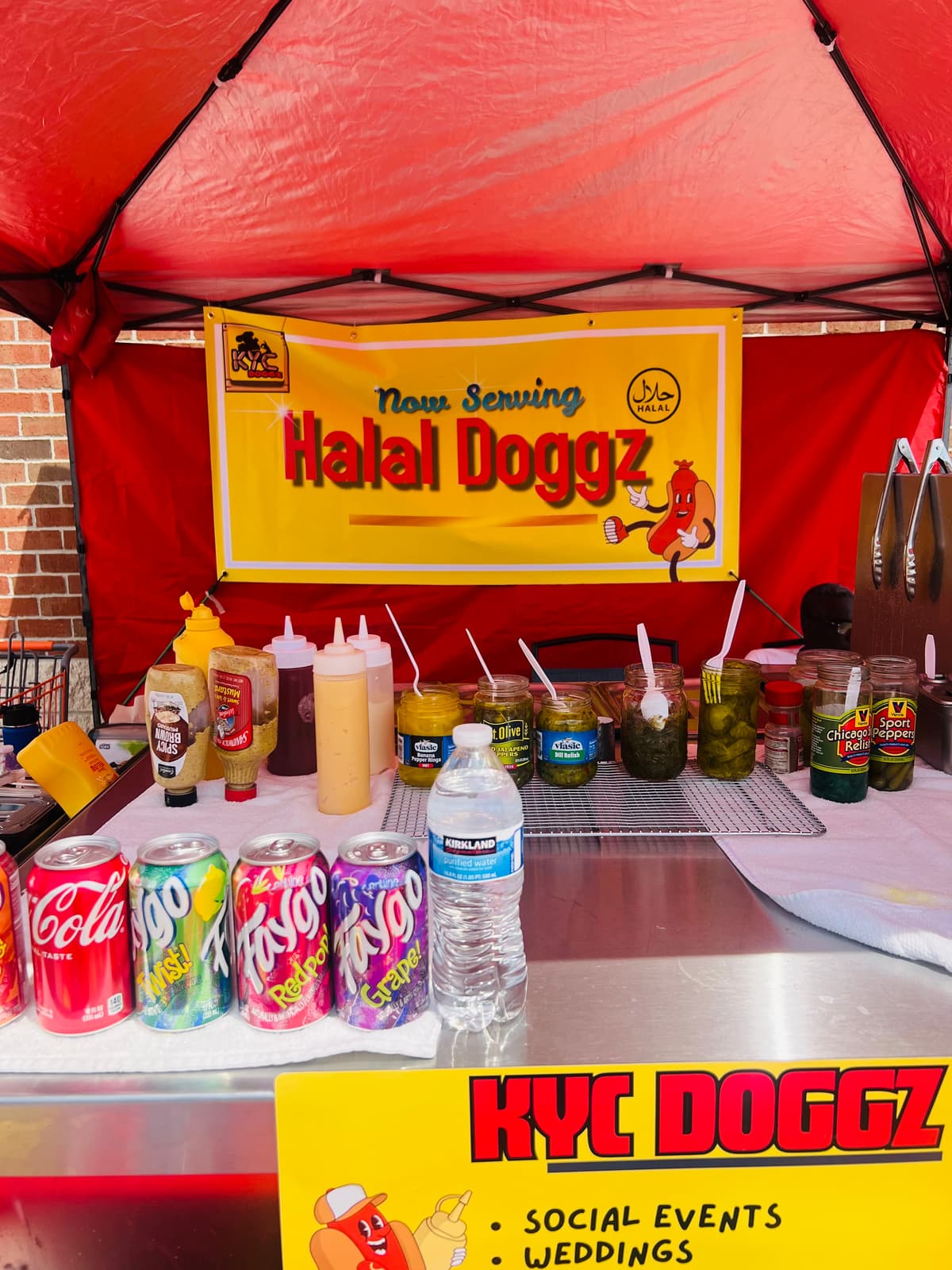 Now Serving Halal Doggz banner with Faygo and condiments